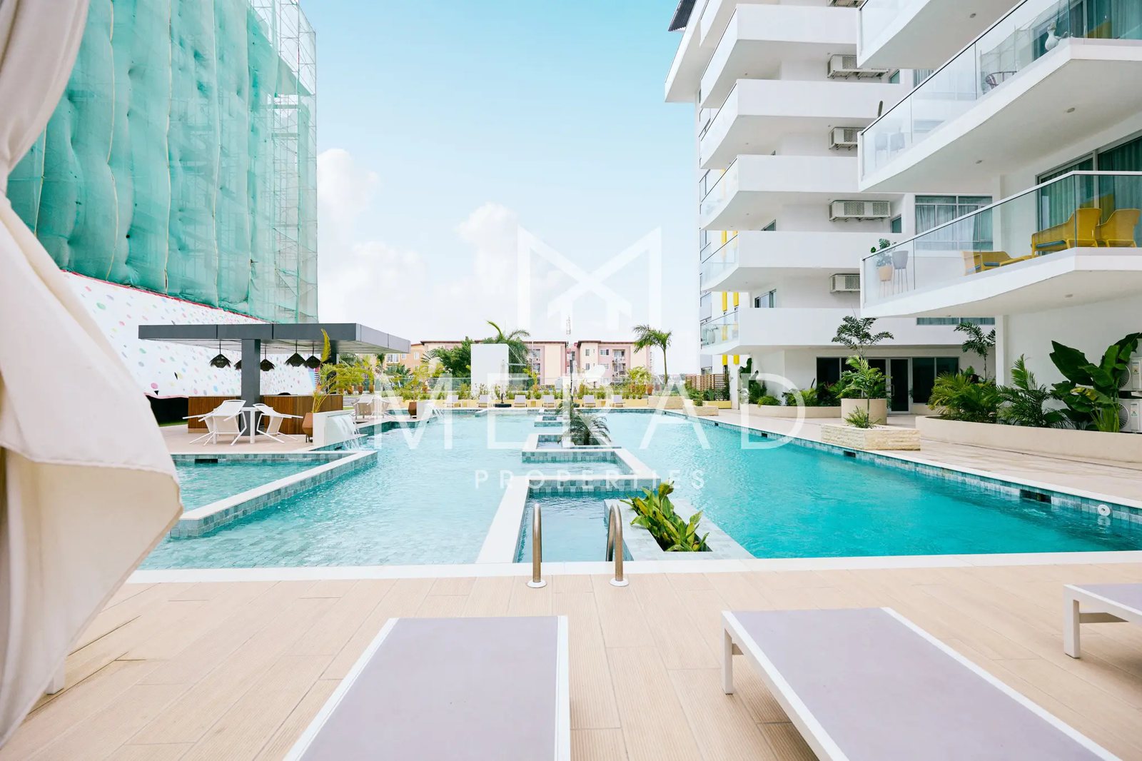 Residents' swimming pool and sun deck at a Merad apartment complex